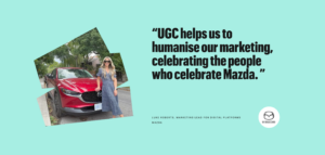 Woman stands by Mazda car